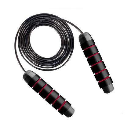 Justerbart hopprep med svarta handtag och rödsvart rep i hoprullat läge  - Stabil Posture